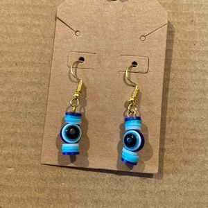 gold and blue evil eye earrings
